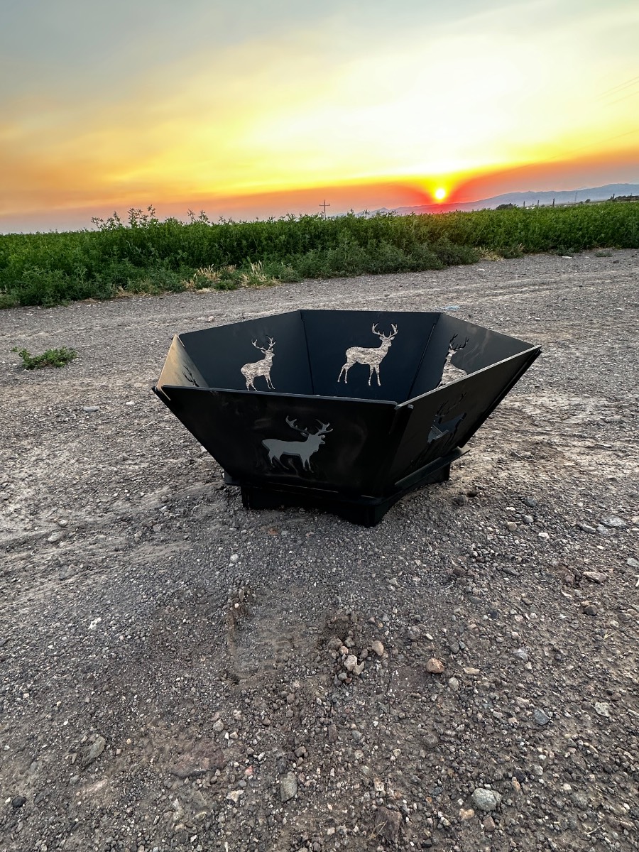 Pre-built fire pit burning beside a camp tent