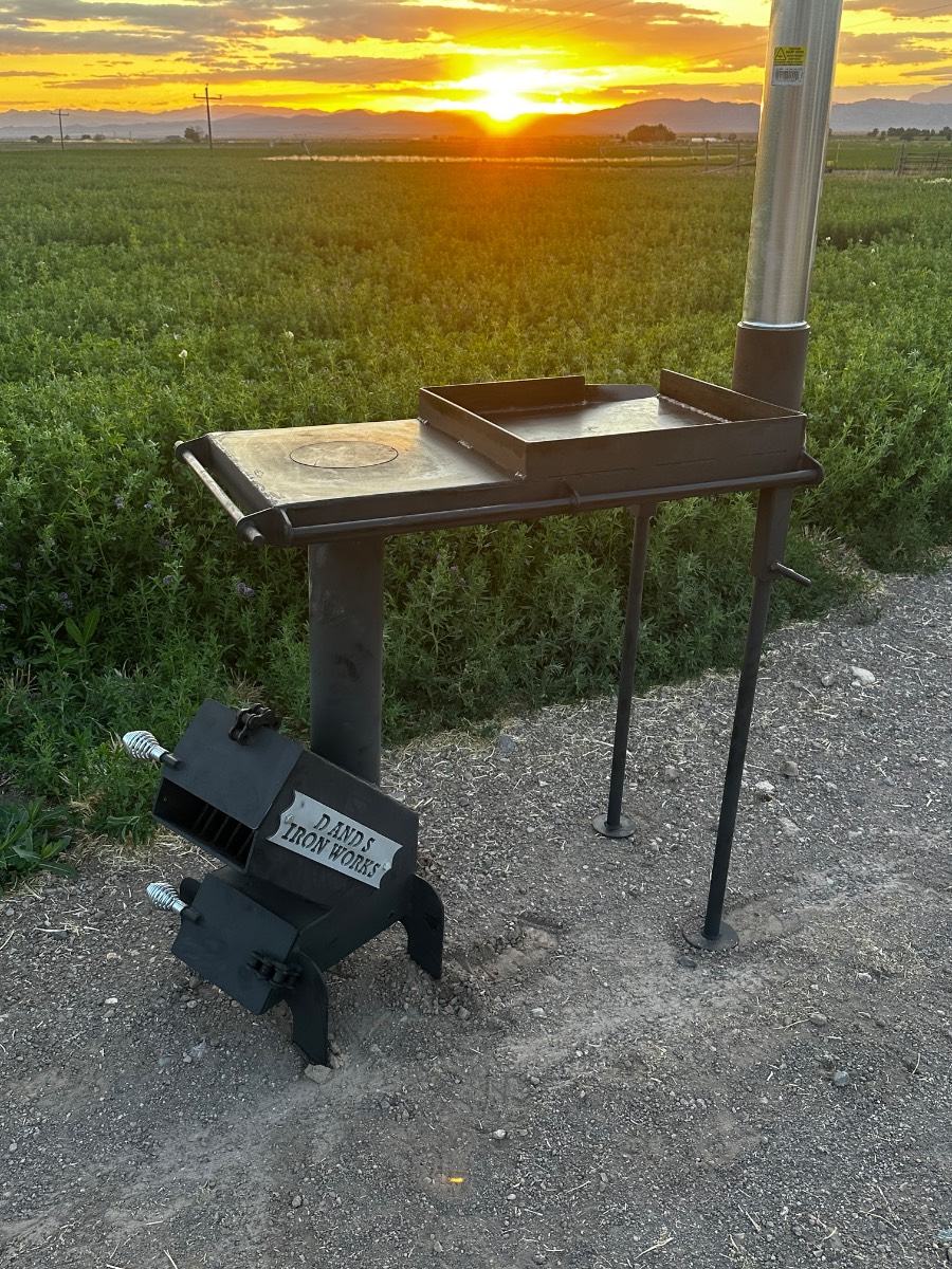 Iron Rocket Stove with griddle cooking food outdoors