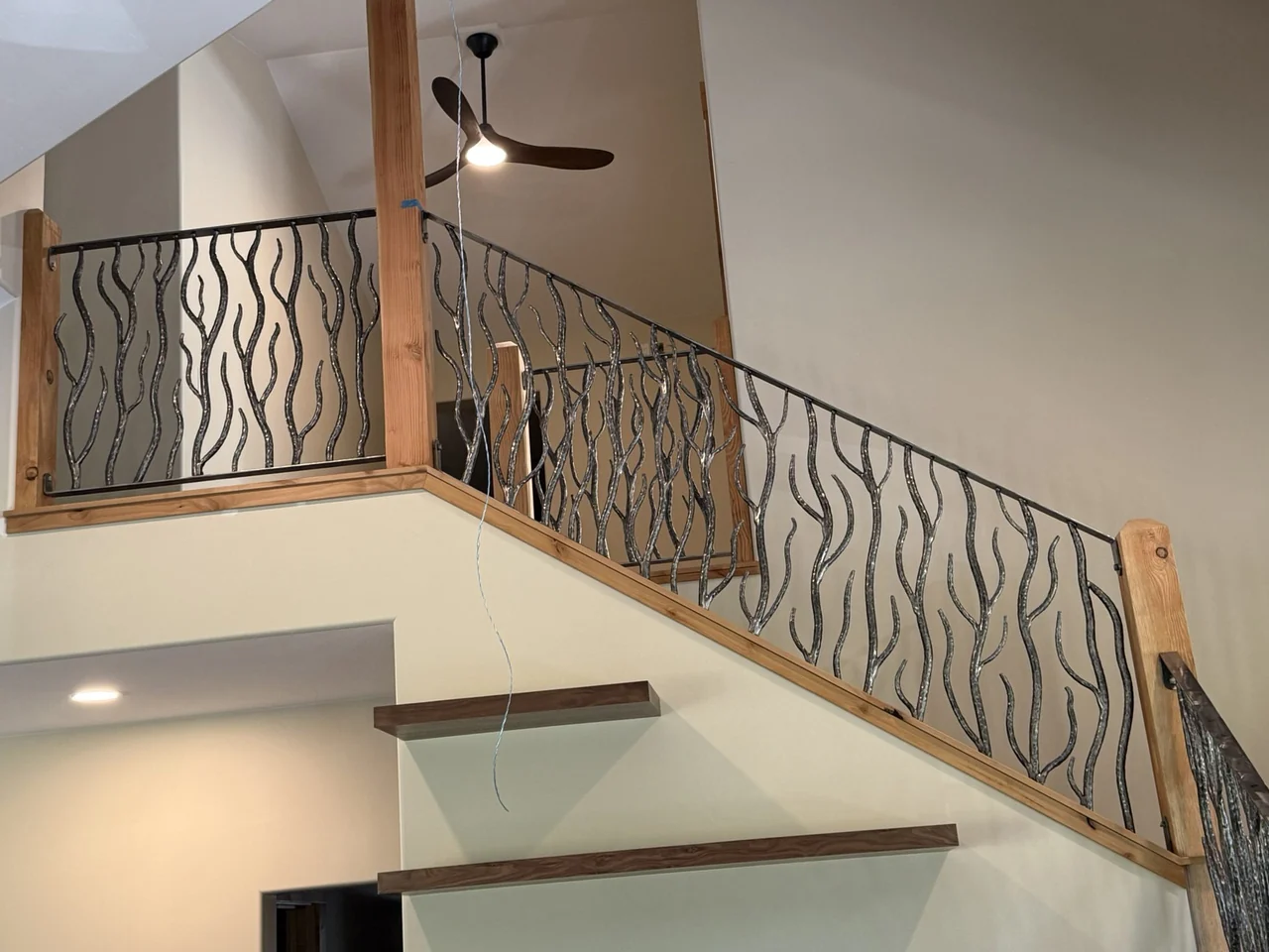 Installed forged balcony railing with organic steel balusters