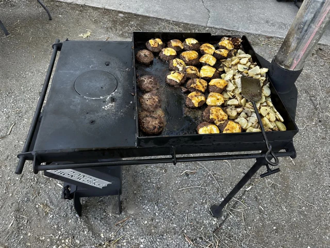 Iron Rocket XL griddle cooking meat and potatoes